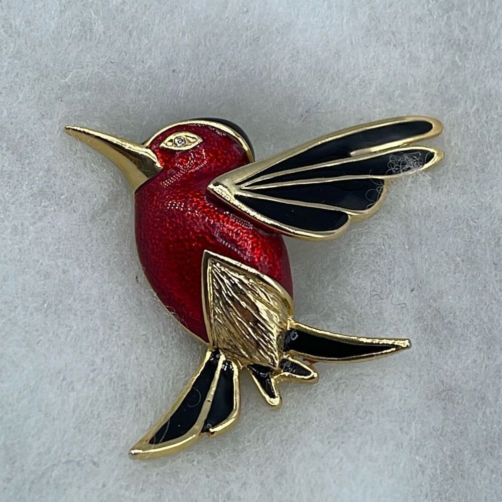 Vintage red enamel hummingbird with rhinestone eye brooch.
